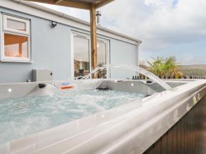 a hot tub with a water fountain on a balcony at The View in Bodmin