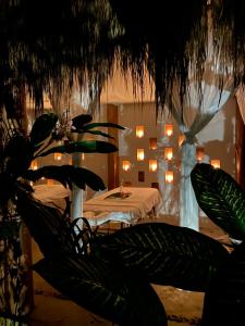 a room with a table with lights in the background at Piedra de Agua Palenque in Palenque