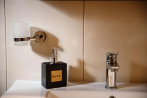 a soap dispenser and a bottle on a counter at Garden house in Neapolis