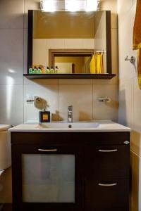 a bathroom with a sink and a mirror at Garden house in Neapolis
