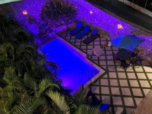 una vista aérea de una piscina con sillas y sombrillas en OASIS Penthouse with private garden & shared pool, en Koolbaai