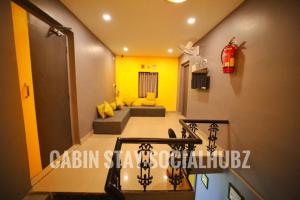 a room with yellow walls and a staircase with yellow accents at CABIN STAY-SOCIAL HUBZ in Mumbai