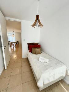 a bedroom with a bed with two towels on it at Chic Apartment Cañada in Córdoba