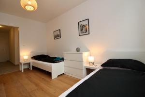 A bed or beds in a room at Modern Balcony Apartment with free Parking