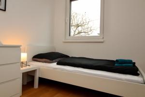 A bed or beds in a room at Modern Balcony Apartment with free Parking