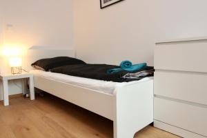A bed or beds in a room at Modern Balcony Apartment with free Parking