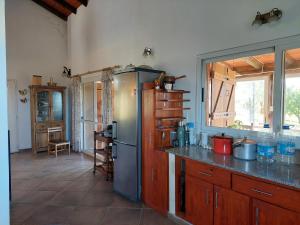 a kitchen with a refrigerator and a counter top at Sol Mayor in Villa Yacanto