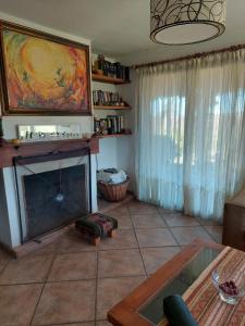 sala de estar con chimenea y mesa en Sol Mayor en Villa Yacanto