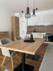 - une cuisine avec une table et des chaises en bois dans l'établissement Ski & Bike Appartements, à Altenmarkt im Pongau