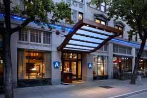 a building with a clock on the front of it at Hotel Andra Seattle MGallery Hotel Collection in Seattle