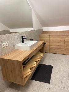 a bathroom with a sink and a counter with towels at Ski & Bike Appartements in Altenmarkt im Pongau