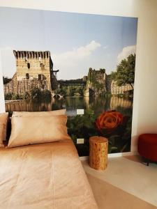 a bedroom with a wall mural of a castle at Una Rosa sul Mincio in Valeggio sul Mincio