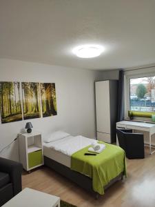 a small bedroom with a bed and a table at Zimmervermietung38 - Nebel in Salzgitter