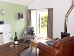 a living room with a couch and a table at Wee Glebe in Moniaive