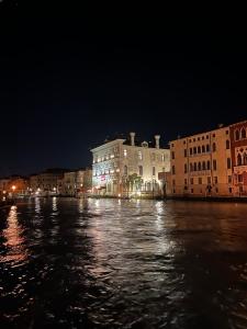 a view of a river at night with buildings at Immobiliare Nk Palazzo Bonvicini in Venice