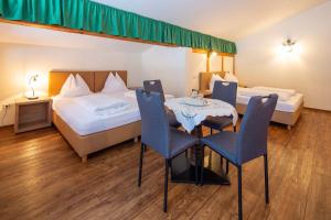 מיטה או מיטות בחדר ב-Ferienhotel Fuchs