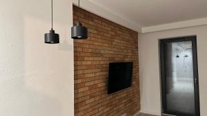 a brick wall with two lights and a speaker on it at Apartamenty Mickiewicza40 in Śrem