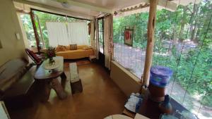 a living room with a large window in a house at Chalés Manhana- Água in Alto Paraíso de Goiás