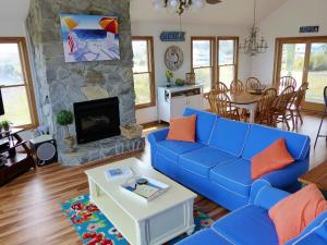 a living room with a blue couch and a fireplace at KH5007- Fore Sea Suns in Kitty Hawk