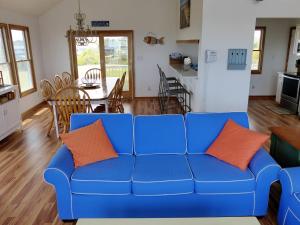 a blue couch in a living room with a table at KH5007- Fore Sea Suns in Kitty Hawk