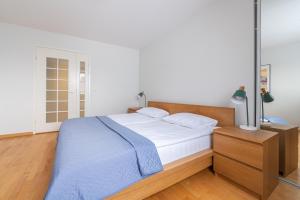 a bedroom with a large bed with a blue blanket at Old Town - Passaaz Apartment in Tallinn