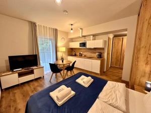 a bedroom with a bed with two towels on it at Apartamenty Pruskie in Karpacz