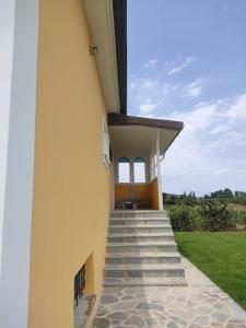 a building with stairs leading up to a building with grass at Casa Dei Fiori in Zakynthos