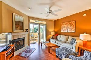 a living room with a couch and a fireplace at Phoenix Condo with Balcony and Spa - 14 Mi to Downtown in Phoenix