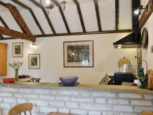 a kitchen with a stone counter top in a room at Bakery Cottage in Ampney Crucis