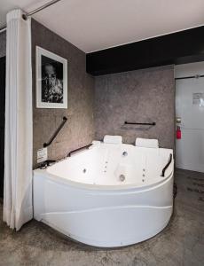 a large white bath tub in a room at BTH Hotel – Boutique Concept in Lima