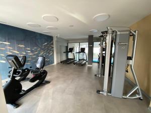 a gym with treadmills and ellipticals in a room at Relax Planet in Rewal