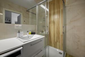 ein Bad mit einem Waschbecken und einer Dusche in der Unterkunft Apartament SUNRISE Kudowa z balkonem in Kudowa-Zdrój