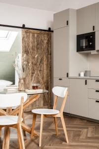 a dining room with a table and two chairs at PO PTOKACH in Czarny Dunajec +22 photos
