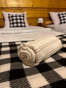 a towel laying on two beds in a room at Na Poddaszu - apartament na wyłączność in Kluszkowce