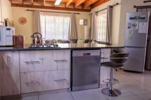 a kitchen with stainless steel appliances and a counter at 515 on Warthog by the River in Marloth Park