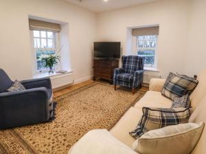 a living room with two couches and a tv at Castle House in Rhyl