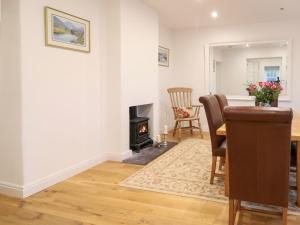 a living room with a table and a fireplace at Castle House in Rhyl