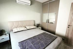 a bedroom with a large bed and a closet at Thalassa Apartment in Nea Peramos