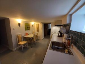 a kitchen with a sink and a table with chairs at Niagara Falls Dream Family Retreat in Niagara Falls