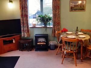 a dining room with a table and a fire place at Yederick Barn in Sawdon
