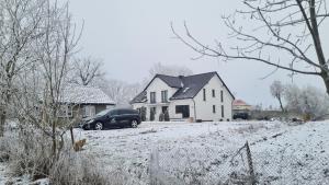 a car parked in front of a house in the snow at RMF Naworol 2 in Szczecin