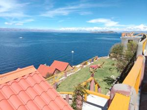 a view of the ocean from a balcony of a house at JACHA INTI in Isla de Sol