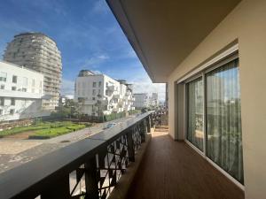 a balcony with a view of a city at Luxury Apart 2 CH -CASA FINANCE CITY in Casablanca
