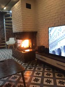 a living room with a fireplace and a television at The My Hotel in Umraniye