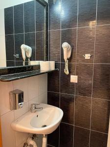 a bathroom with a sink and a mirror at Bella Mare Villa Sithonia in Akti Salonikiou