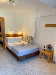 ein Schlafzimmer mit einem großen Bett und einem Tisch in der Unterkunft Bella Mare Villa Sithonia in Akti Salonikiou