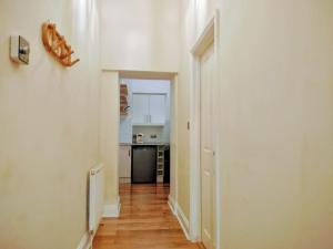 an empty hallway with a kitchen and a hallwayngth at Seagulls Nest- stylish 1 bed seafront apartment in Hastings