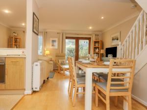 a kitchen and dining room with a table and chairs at Oyster Cottage in Falmouth