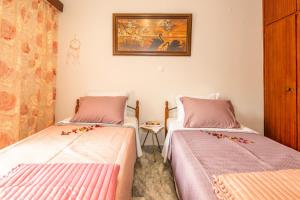 Habitación con 2 camas y una foto en la pared. en Stratos Seaside corner apartment, en Rethymno