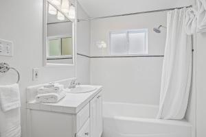 a white bathroom with a sink and a shower at Casa Mesa in Santa Barbara +23 photos